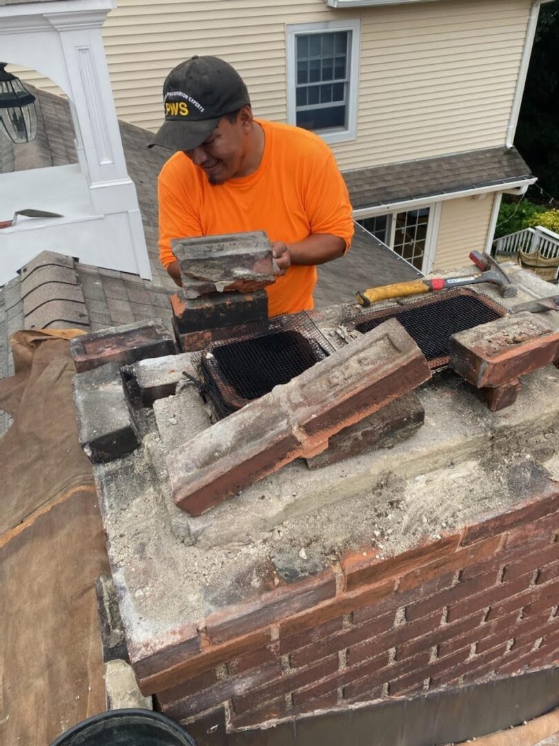 A man working on the roof of a house